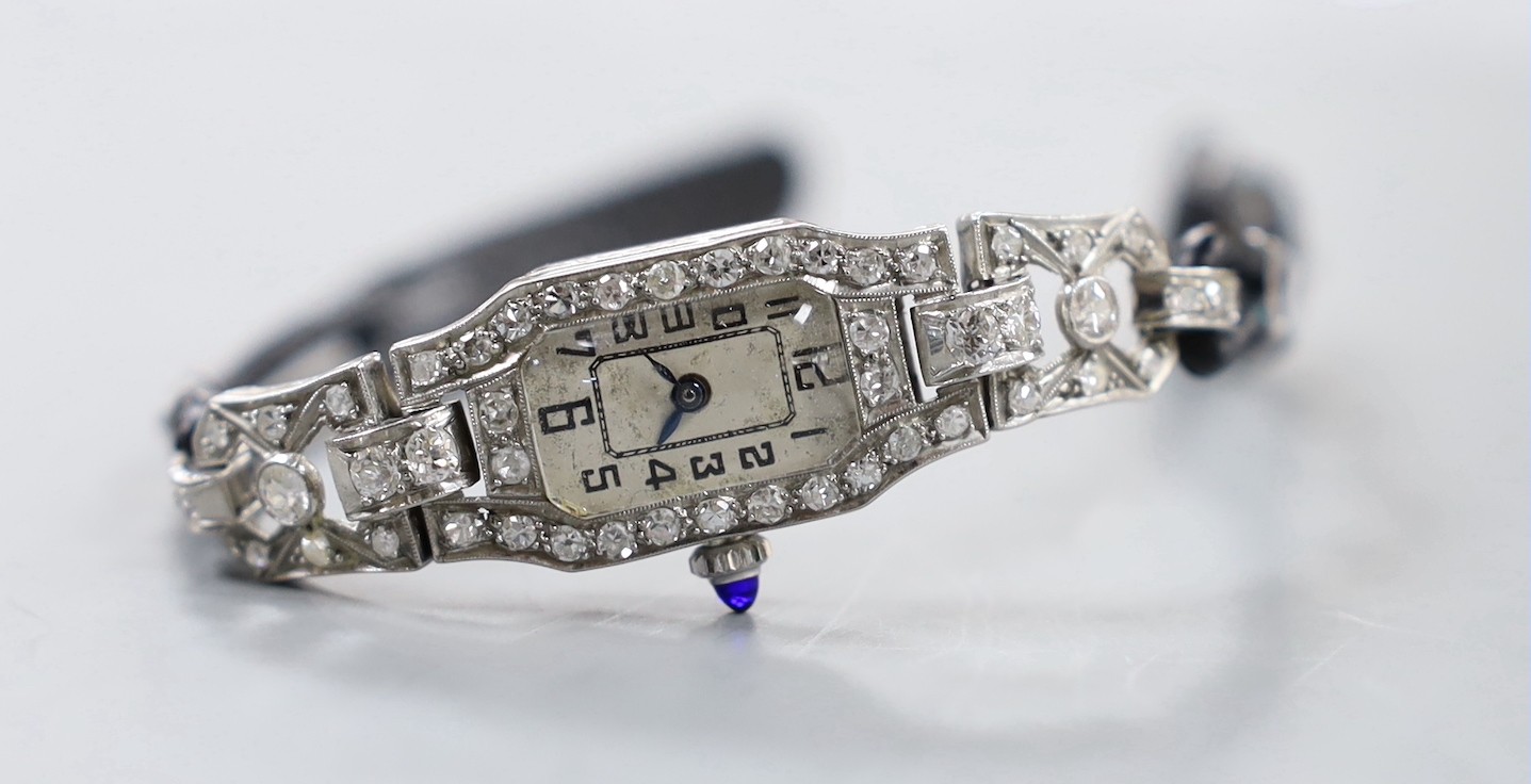 A lady's 1940's white metal (stamped plat) and diamond set manual wind cocktail watch, with Arabic dial, on fabric strap, gross weight 15.7 grams.